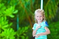 Adorable happy girl at beach with colorful little Royalty Free Stock Photo