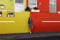 a adorable happy girl take a photo against the colorful wall, in Bo Kaap Quarter street, Cape Town