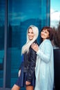 Adorable happy ladies brunette and blonde looking at the camera Royalty Free Stock Photo