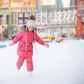 Adorable happy little girl enjoying skating at the Royalty Free Stock Photo