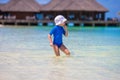 Adorable happy little girl playing at shallow