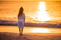 Adorable happy little girl on white beach at sunset. Royalty Free Stock Photo