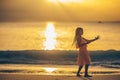 Adorable happy little girl on white beach at sunset. Royalty Free Stock Photo