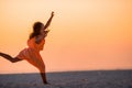 Adorable happy little girl on white beach at sunset. Royalty Free Stock Photo