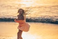 Adorable happy little girl on white beach at sunset. Royalty Free Stock Photo