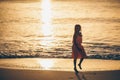 Adorable happy little girl on white beach at sunset. Royalty Free Stock Photo