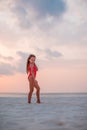 Adorable happy little girl on white beach at sunset. Royalty Free Stock Photo