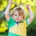 Adorable happy little kid boy holding tablet pc, outdoors Royalty Free Stock Photo