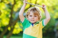 Adorable happy little kid boy holding tablet pc, outdoors Royalty Free Stock Photo