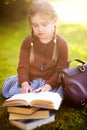 Preschool girl reading books. Little genius concept. Royalty Free Stock Photo