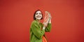 Adorable happy smiling face brunet girl holding slice of watermelon and looking side.