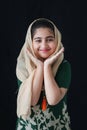 Adorable happy smiling Pakistani Muslim girl with beautiful eyes wearing hijab and traditional costume. Portrait of pretty cute Royalty Free Stock Photo