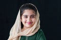 Adorable happy smiling Pakistani Muslim girl with beautiful eyes wearing hijab and traditional costume. Portrait of pretty cute Royalty Free Stock Photo