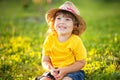 Adorable happy todder girl with staw hat, little farmer