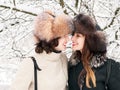 Adorable happy young brunette women girlfriends in fur hats having fun snowy winter park forest in nature Royalty Free Stock Photo