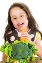 Adorable healthy little girl holding a carrot