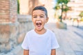 Adorable hispanic boy smiling happy at the city