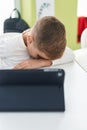 Adorable hispanic boy student tired leaning on the desk at classroom Royalty Free Stock Photo