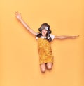 Adorable hispanic child girl wearing vintage aviator helmet and goggles smiling happy