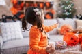 Adorable hispanic girl having halloween party playing with soap bubbles at home Royalty Free Stock Photo