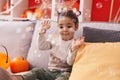 Adorable hispanic girl having halloween party playing with soap bubbles at home Royalty Free Stock Photo