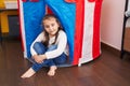 Adorable hispanic girl smiling confident sitting inside circus tent at kindergarten
