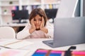 Adorable hispanic girl student using laptop with worried expression at classroom Royalty Free Stock Photo