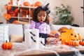 Adorable hispanic toddler having halloween party standing at home