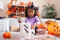 Adorable hispanic toddler having halloween party standing at home