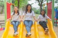 Adorable and Holiday Concept : Woman and cute little children feeling funny and happiness on a slide at playground. Royalty Free Stock Photo