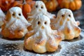 Adorable Homemade Ghost Shaped Halloween Treats on a Kitchen Table Dusting with Powdered Sugar