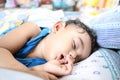 An adorable indian baby with one tooth sleeping with finger in mouth Royalty Free Stock Photo