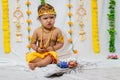 adorable infant dressed as hindu god krishna on the occasion of janmashtami celebrated at india