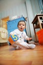 Adorable infant plays in the room, soft focus