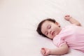 Adorable innocent baby girl sleeping on bed with good dream. Cute mixed race infant baby feel comfortable and taking a rest, Royalty Free Stock Photo