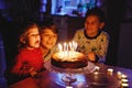 Adorable kid boy celebrating tenth birthday. Baby sister child and two kids boys brothers blowing together candles on Royalty Free Stock Photo