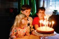 Adorable kid boy celebrating tenth birthday. little toddler girl, sister child and two kids boys brothers blowing Royalty Free Stock Photo