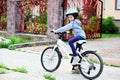 Adorable kid girl in blue helmet riding her bike Royalty Free Stock Photo