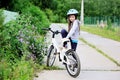 Adorable kid girl in blue helmet riding her bike Royalty Free Stock Photo