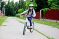 Adorable kid girl in blue helmet riding her bike Royalty Free Stock Photo