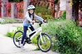 Adorable kid girl in blue helmet riding her bike Royalty Free Stock Photo