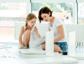 Girl and mother installing new furniture