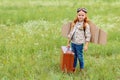 adorable kid in pilot costume with retro suitcase standing Royalty Free Stock Photo