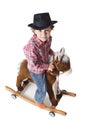 Adorable kid riding a toy horse