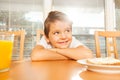 Adorable kid sitting in the kitchen at breakfast Royalty Free Stock Photo