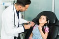 Adorable kid telling a pediatrician her symptoms