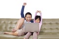 Adorable kids cheering while operating a laptop Royalty Free Stock Photo