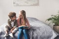 adorable kids looking at each other while reading book together Royalty Free Stock Photo