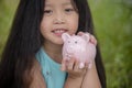 Adorable kids saving coins in piggy bank. Happy little investment saving money for happiness future. Girls smiling    with happy Royalty Free Stock Photo