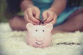 Adorable kids saving coins in piggy bank. Happy little investment saving money for happiness future. Girls smiling    with happy Royalty Free Stock Photo